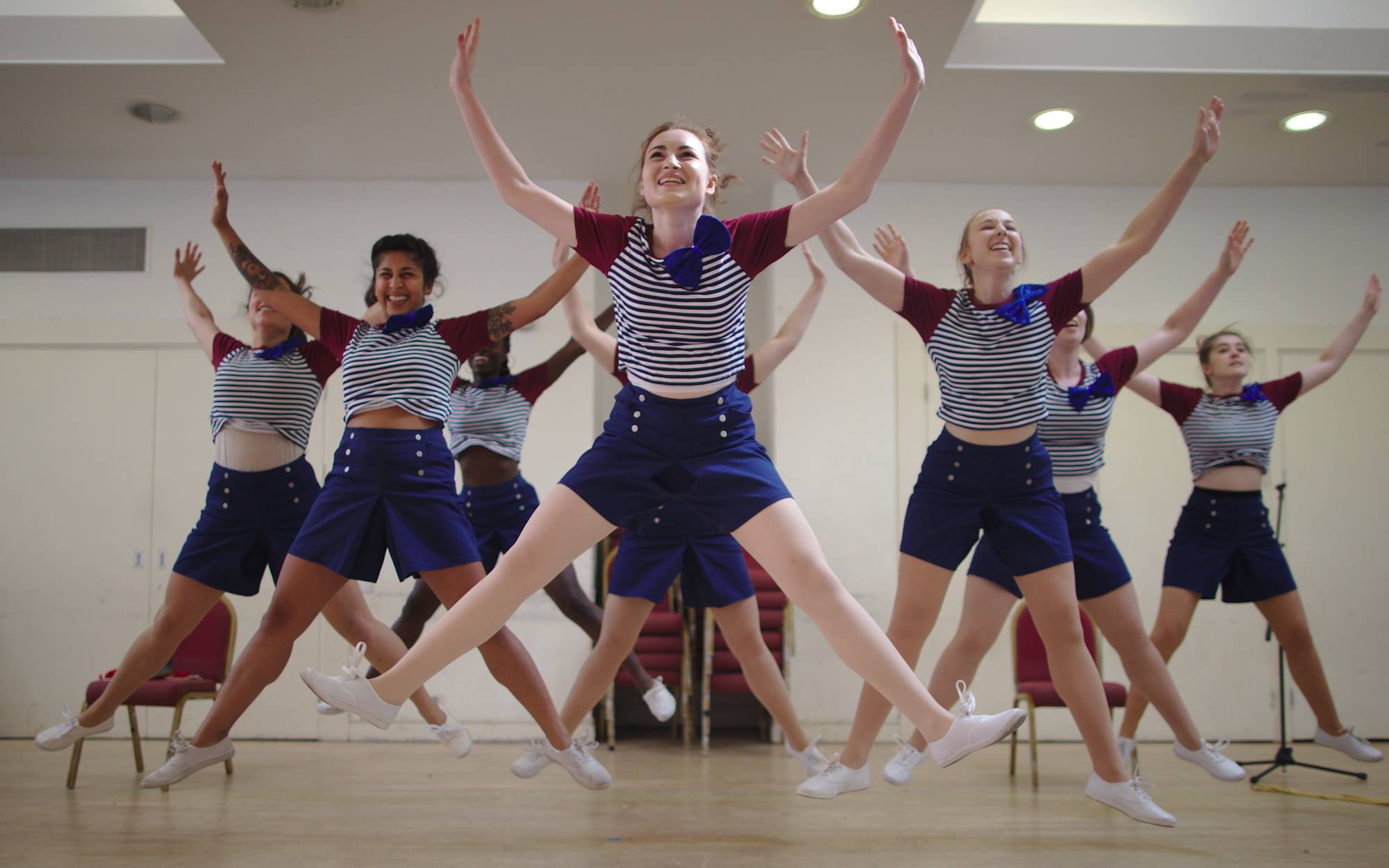 The Starlings star jumping in a V formation in a rehearsal studio
